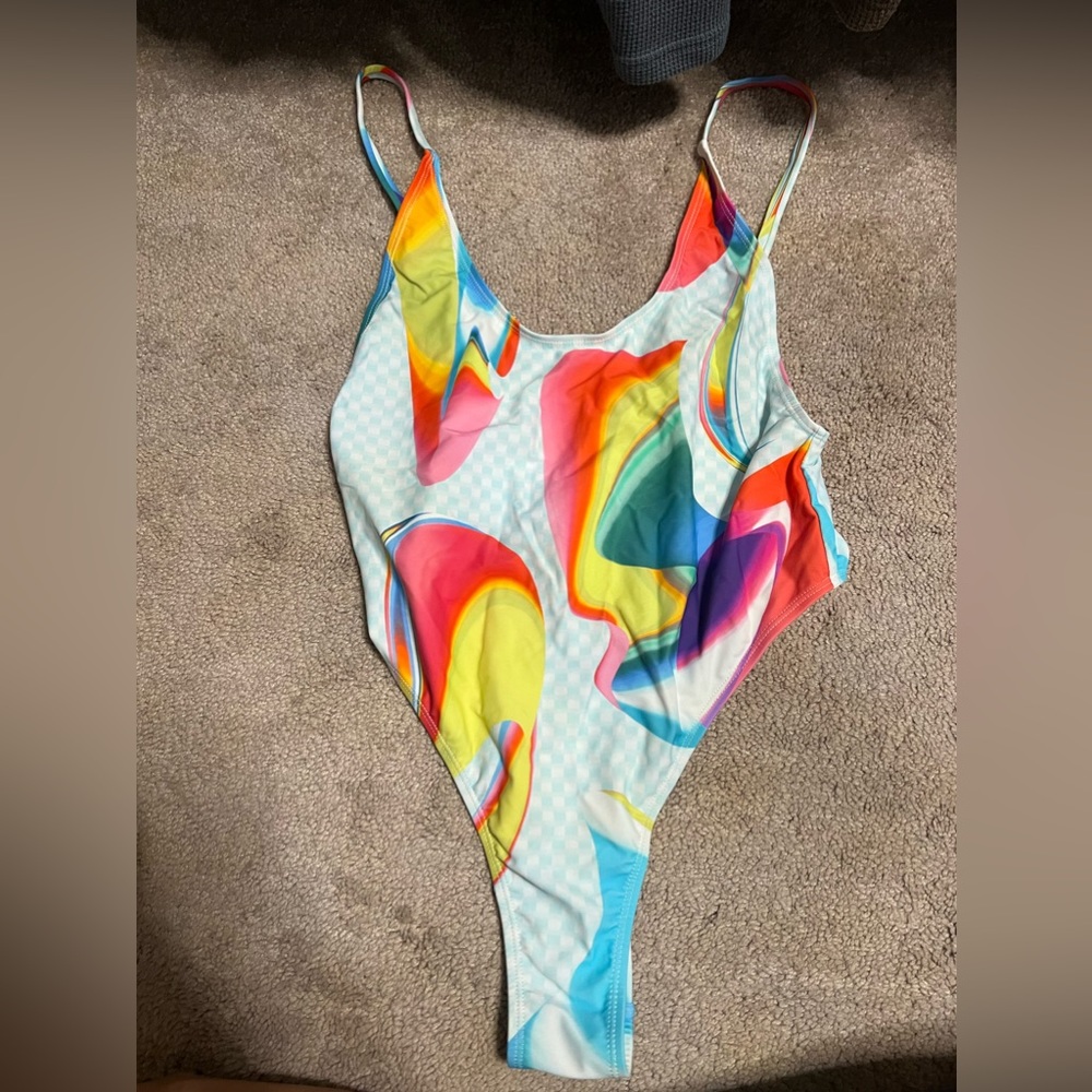 One-piece swimsuit. Brand is fabletics - pride collection.